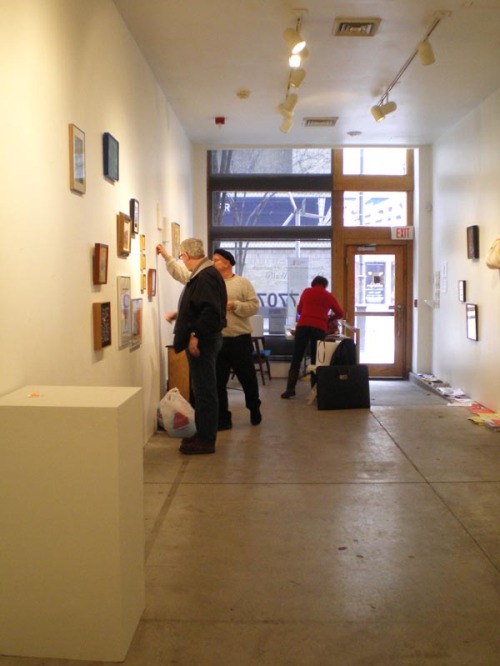 photo of people taking down artwork in a gallery