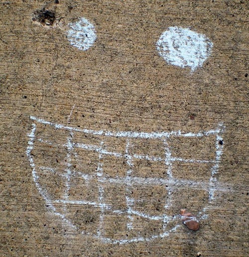 photo of smiley face on sidewalk