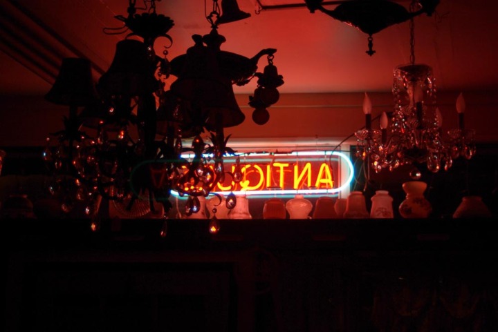 neon sign in an antique shop at night