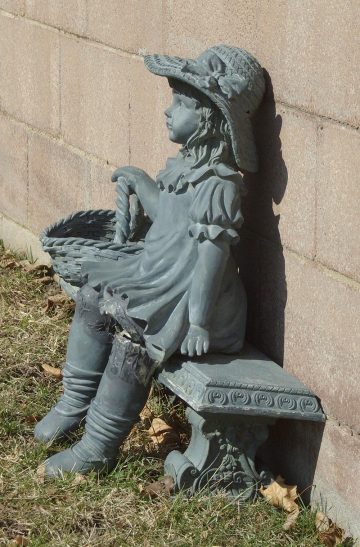photo of verdegris statue of little girl