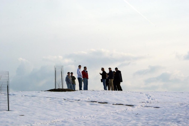 group of people standing in snow