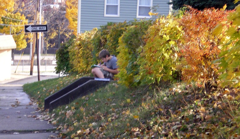 One of my neighborhood friends doing his homework on a warm autumn afternoon.
