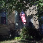 photo of porch with flag under tree