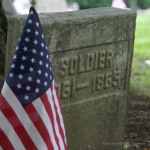 civil-war era headstone with flag